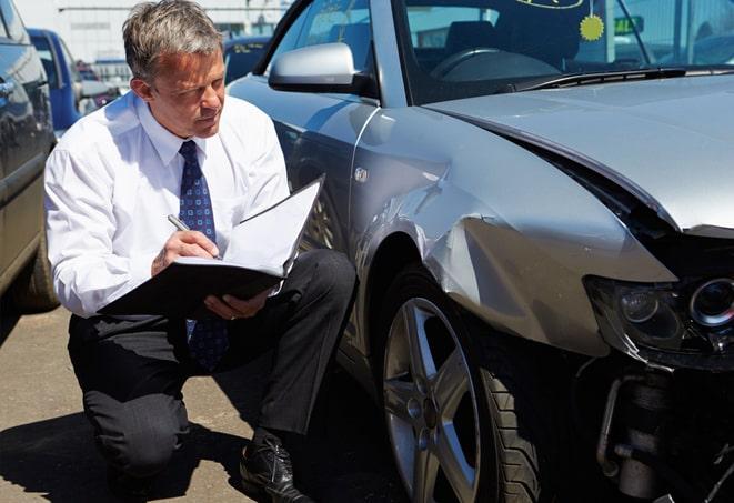 car insurance policy document and pen on table